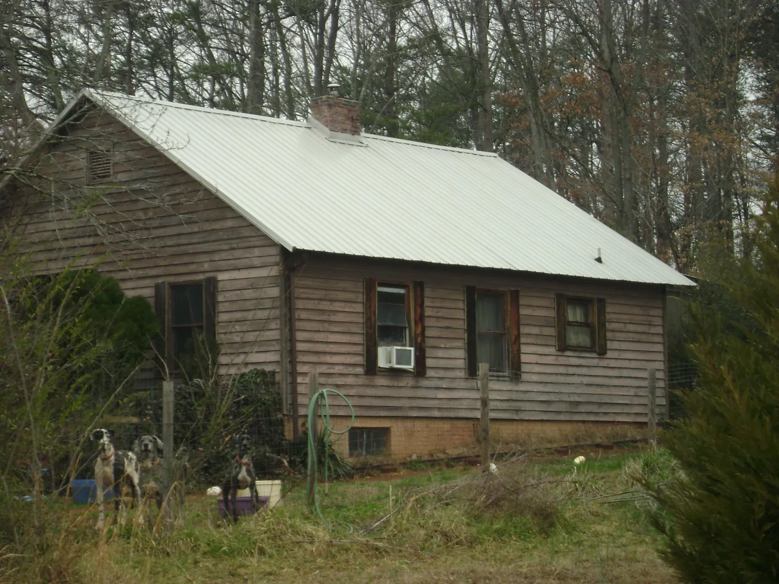 White metal roof on an old wood sided farmhouse, from a Metal Roof Installation job in East Otis
